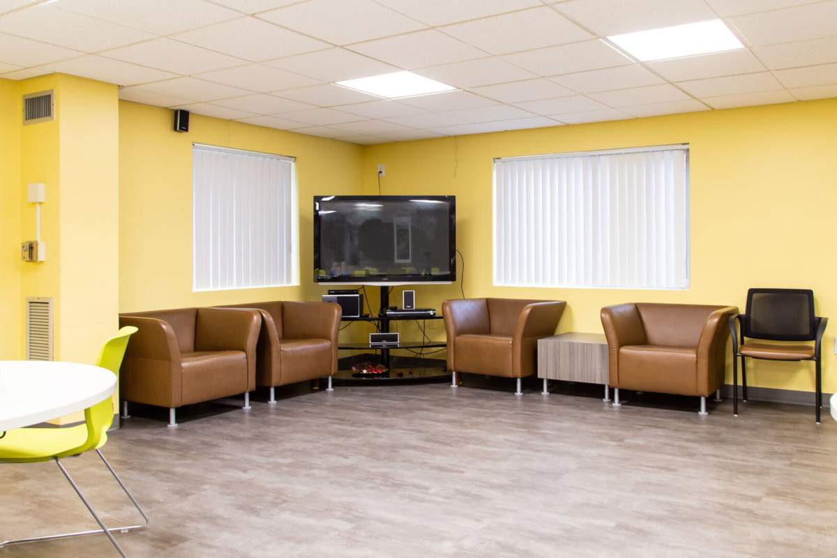 Indoor seating area with flat-screen TV at Cardinal Medeiros Manor in Dorchester, Massachusetts,