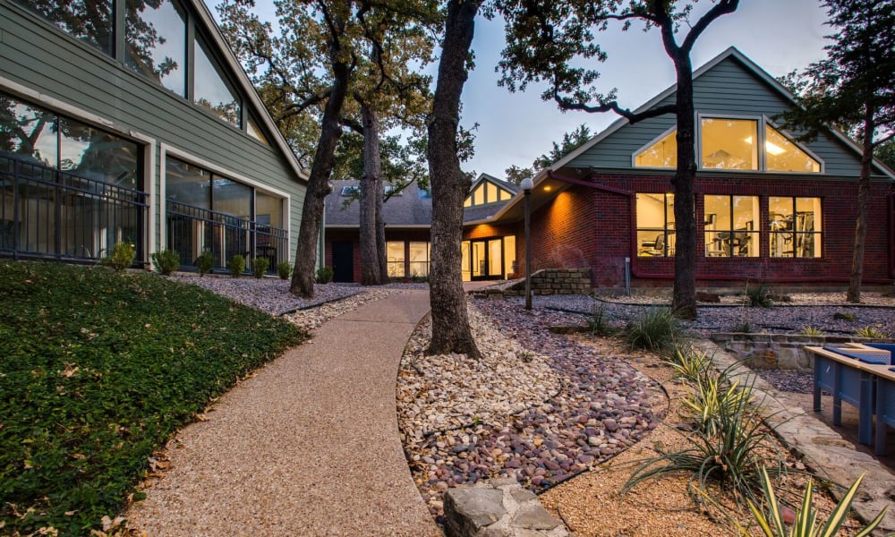 A walkway leading to the community clubhouse at Verandahs at Cliffside Apartments in Arlington, Texas