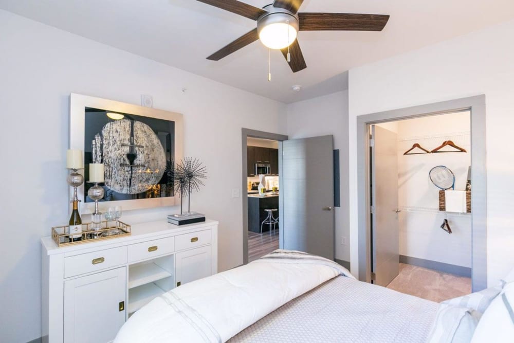Model bedroom with walk-in closet and plush carpeting at Argon in Oklahoma City, Oklahoma
