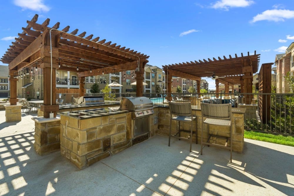 Grilling stations with counter seating on the outdoor patio at Auberge of Burleson in Burleson, Texas