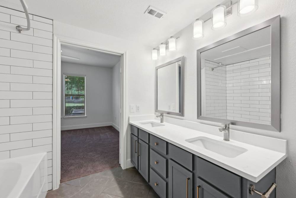 Bathroom with dual sinks at Trinity Bluff & Trinity District in Fort Worth, Texas