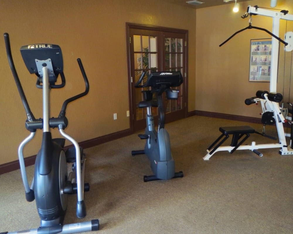 Fitness center with exercise machines at  San Marco Apartments in Ormond Beach, Florida