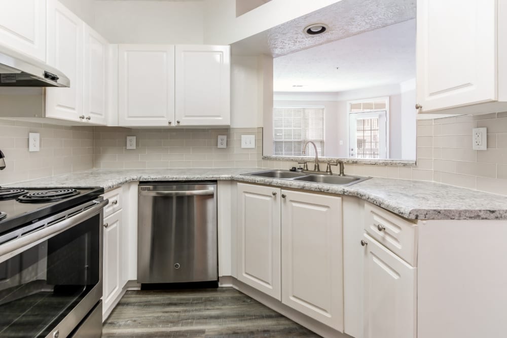 Bright kitchen with wood flooring and stainless steel appliances at Marquis at Sugarloaf in Duluth, Georgia