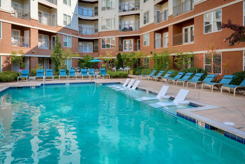 Swimming pool with lounge beds at Helios in Englewood, Colorado