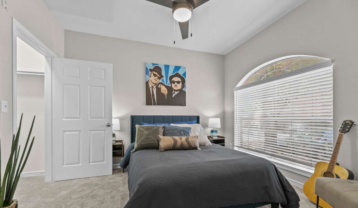 Spacious bedroom with a large bed and windows at Station 3700 in Euless, Texas