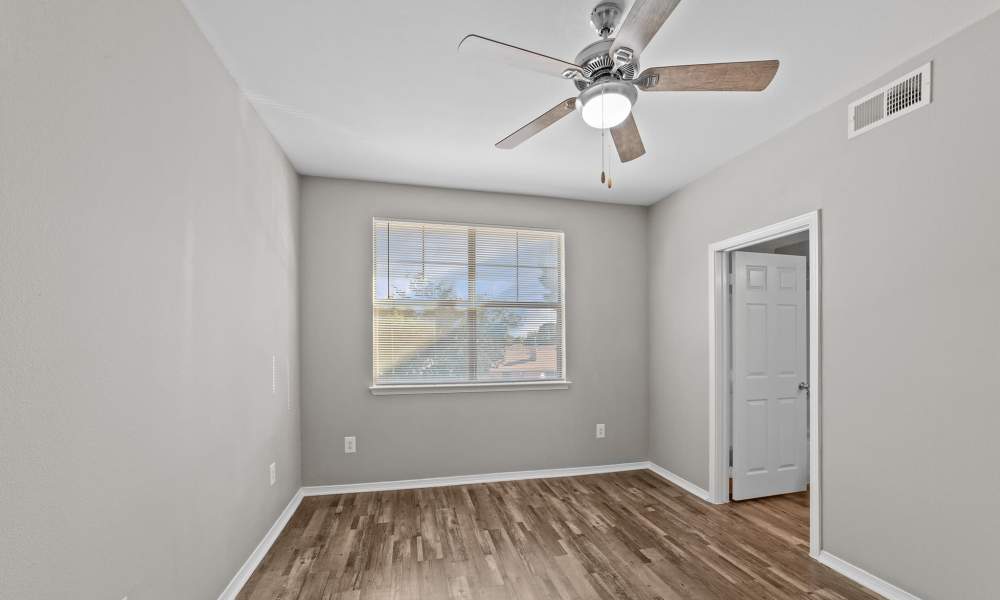 Spacious bedroom with ceiling fan at Burkburnett Residences in Burkburnett, Texas