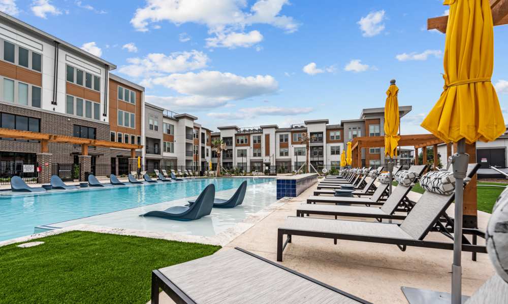 Swimming pool with lounge beds at Opal Point at Kyle in Kyle,Texas