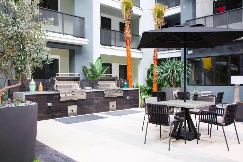 BBQ setup available with seating arrangement at The George Apartment Homes in Anaheim, California