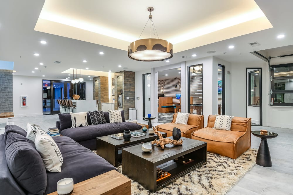 Resident common area with trendy lighting and leather seats at Soba Apartments in Jacksonville, Florida