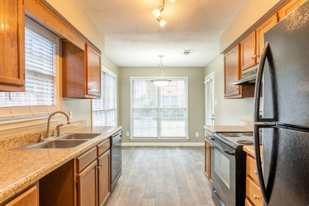 Kitchen with black fridge at The Gatsby at Midtown Apartment Living in Montgomery, Alabama