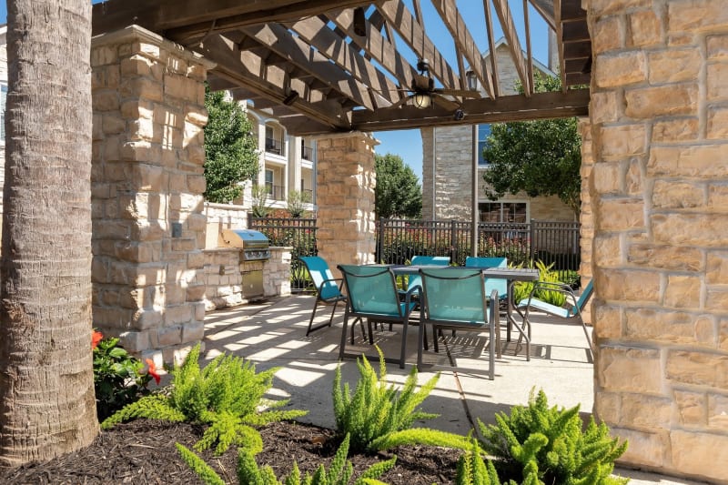 Barbecue area with gas grills overlooking the swimming pool at The Retreat at Cinco Ranch in Katy, Texas