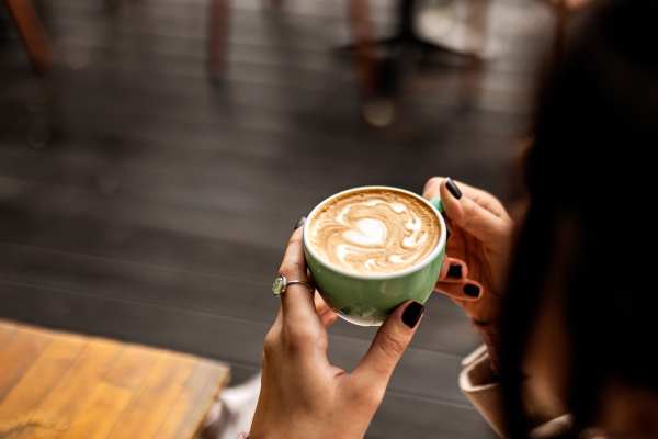 Woman having coffee at restaurant near 544 Southern Apartments in Mesa,Arizona
