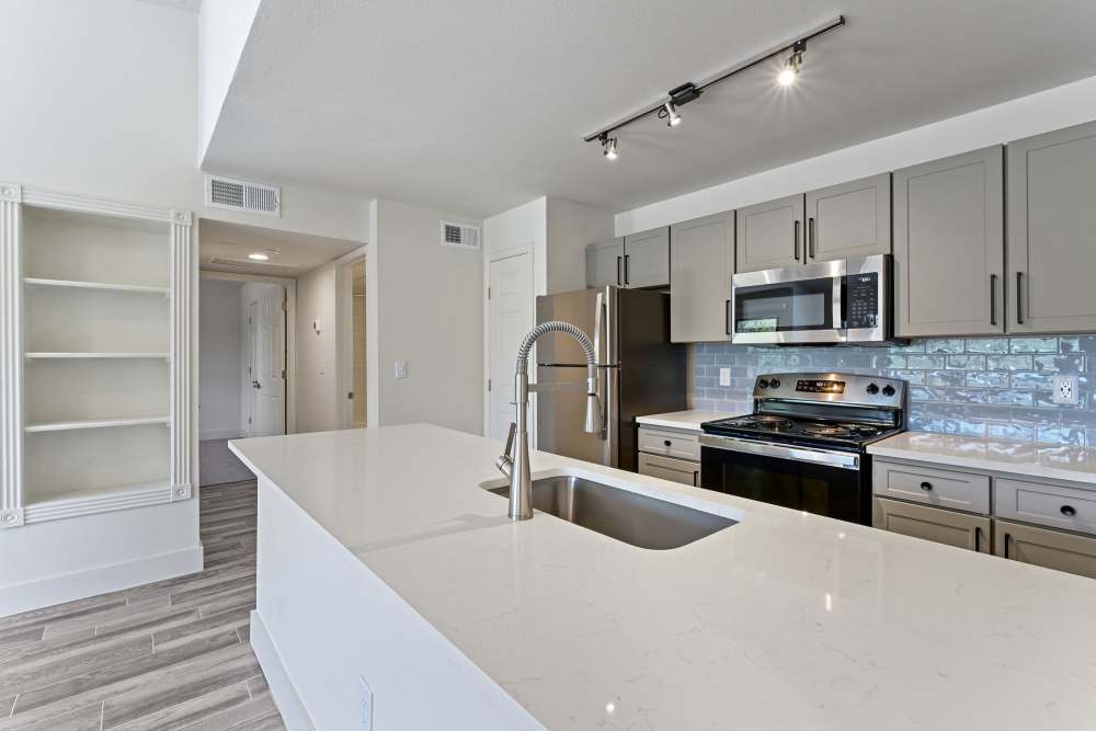 Fully equipped kitchen with appliances and granite countertops at Seacrest in Katy, Texas