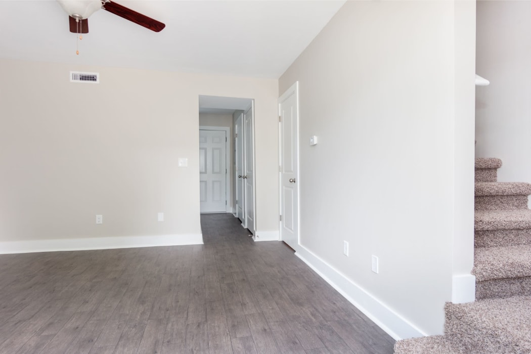 Living room with carpeting and ceiling fan at The Hills at Oakwood Apartment Homes in Chattanooga, Tennessee