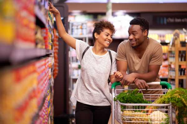 Two people smiling in a grocery aisle near Dakota at Hillcroft in Houston, Texas