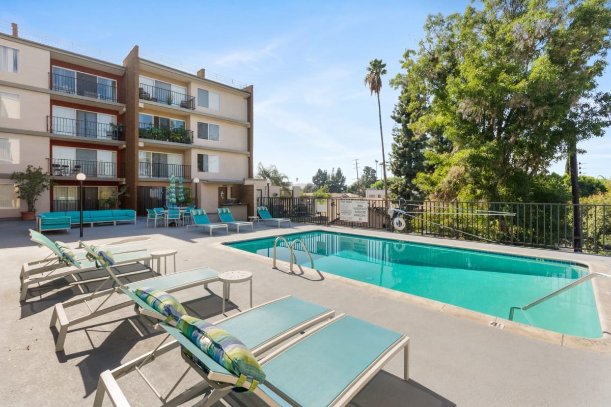 Pool patio with lounge chairs at Amanda Regency Apartments, Van Nuys, California