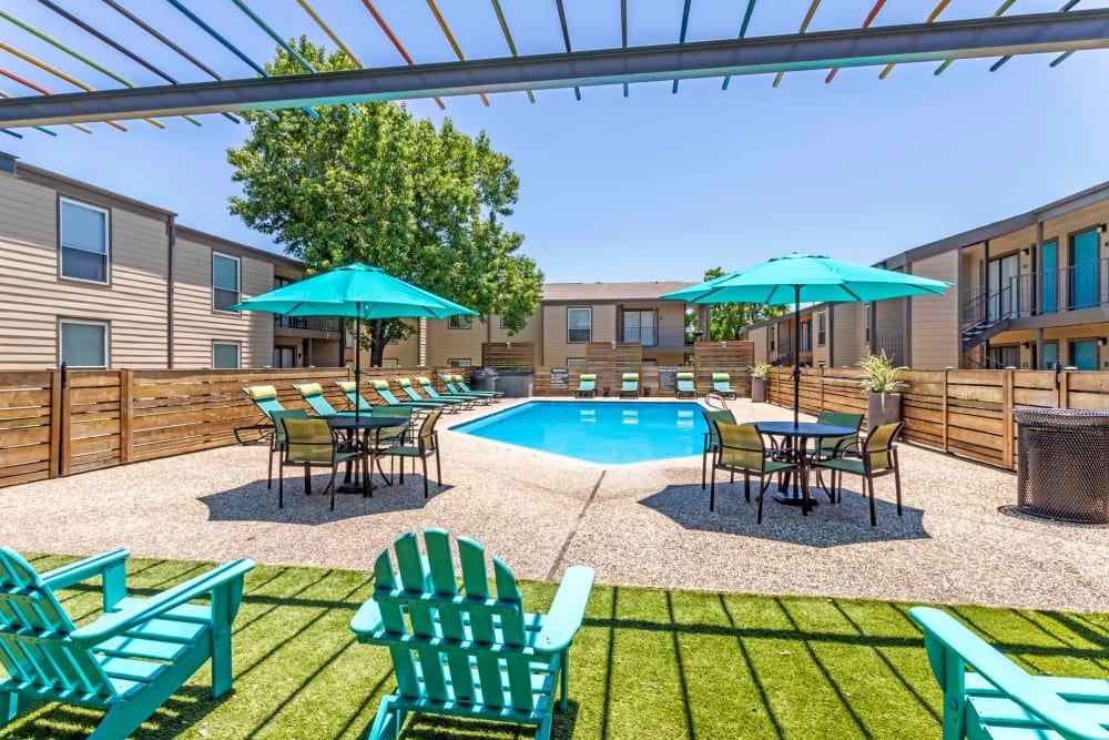 Sunny lounge area and pool at Sausalito Apartments in College Station, Texas
