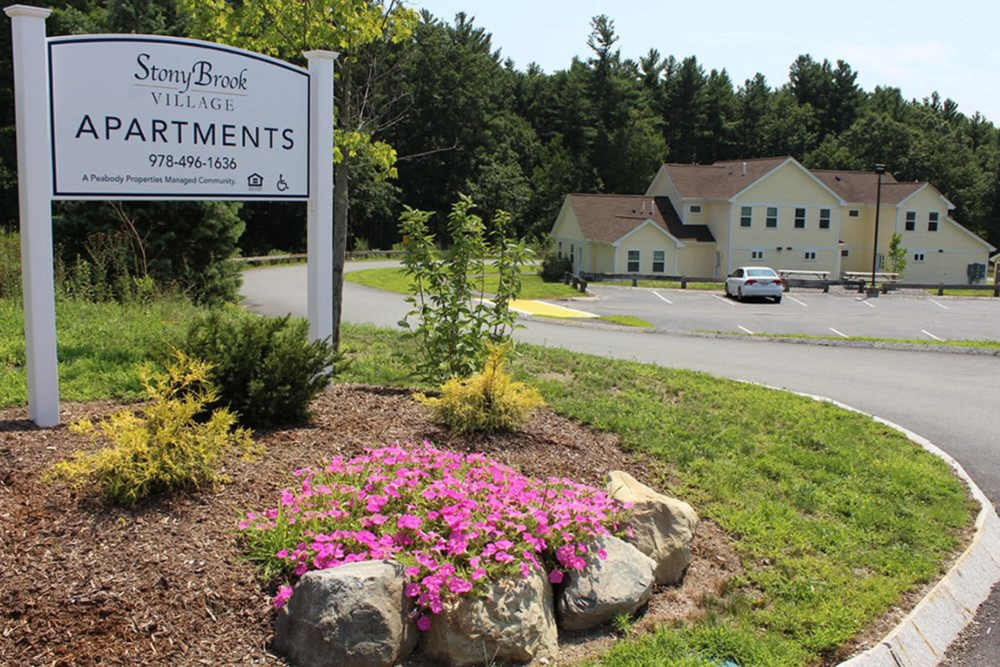 Apartment community sign with flowers near Stony Brook Village in Westford, Massachusetts