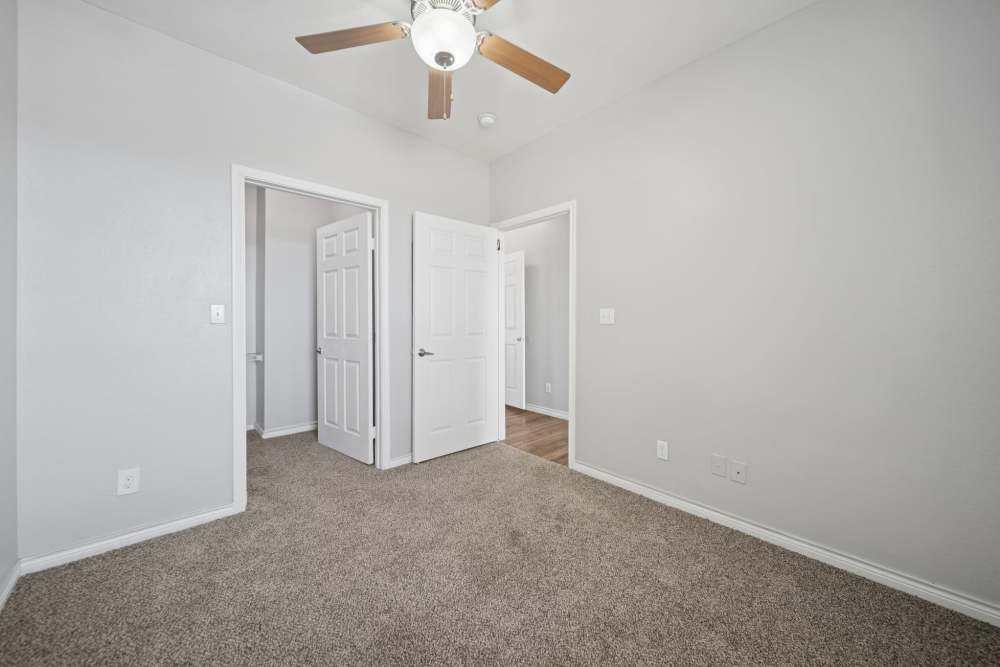 Unfurnished bedroom with closet and entry door at Village at Carlsbad in Carlsbad, New Mexico