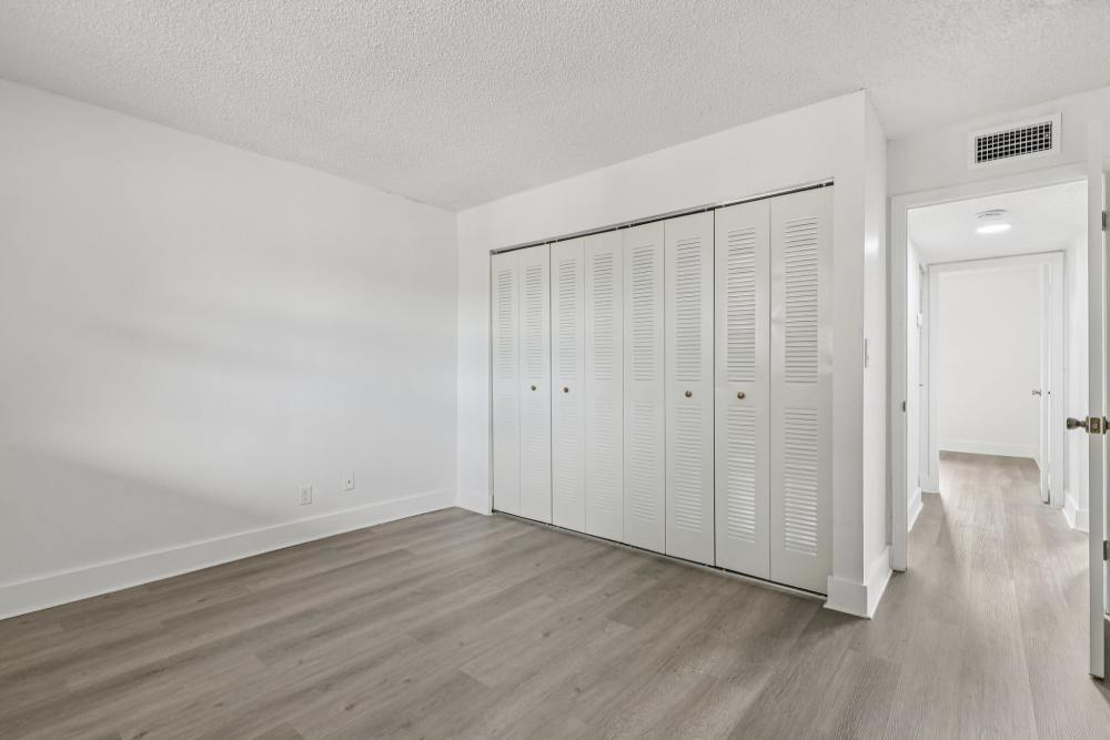 Hallway view and bedroom at El Jardin Apartments in Hollywood, Florida