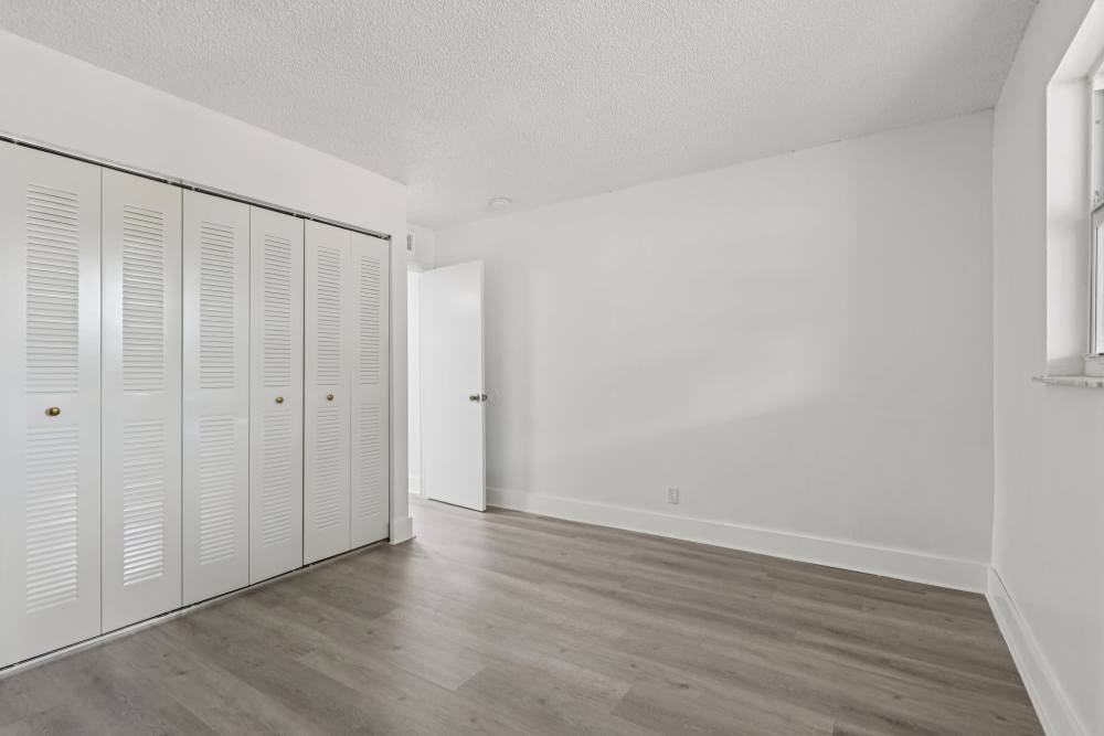 Bedroom with spacious closets at El Jardin Apartments in Hollywood, Florida