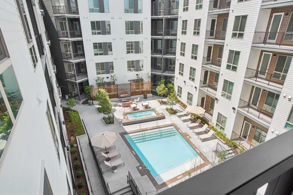 Aerial view of apartment courtyard with pool, hot tub, and seating at Tempo at Nine Mile Station in Aurora, Colorado