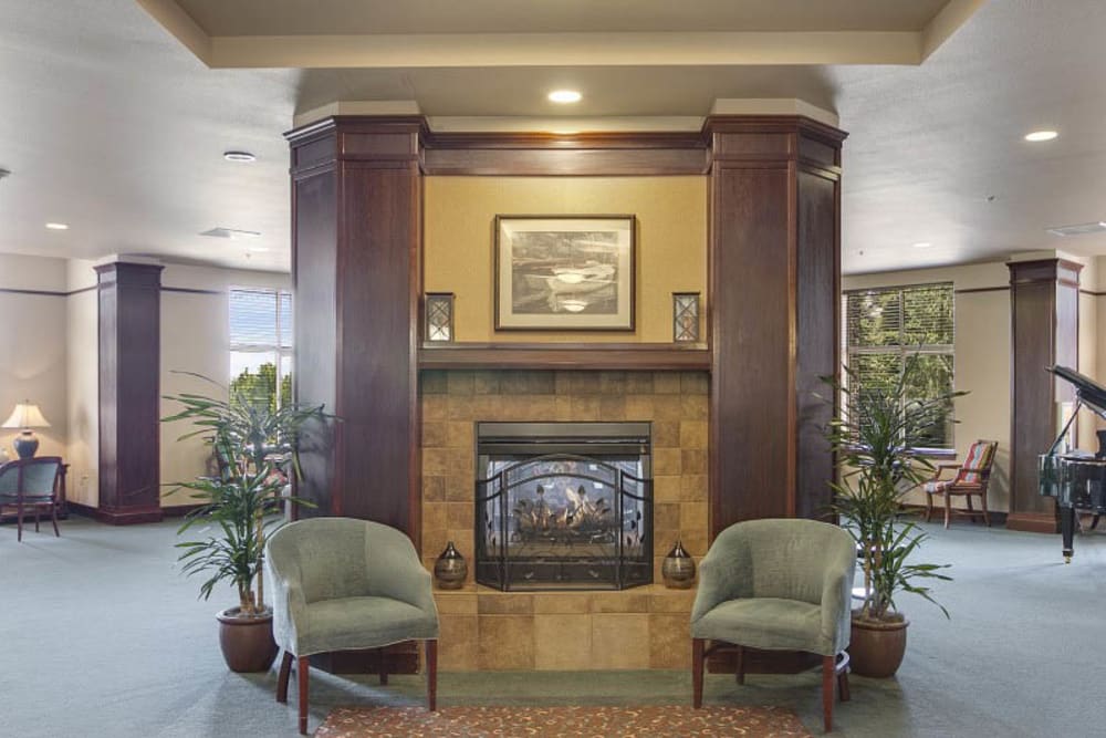 Lobby with fireplace at Merrill Gardens at Huntington Beach in Huntington Beach, California. 