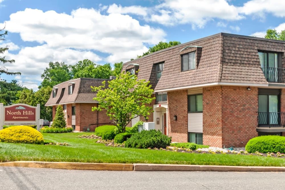 Sunny exterior of North Hills Apartments in Colonia, New Jersey