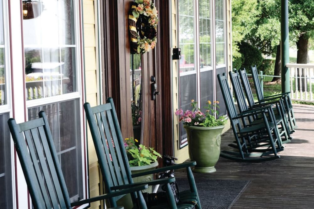 Row of chairs on the front porch at Quail Park of Granbury in Granbury, Texas