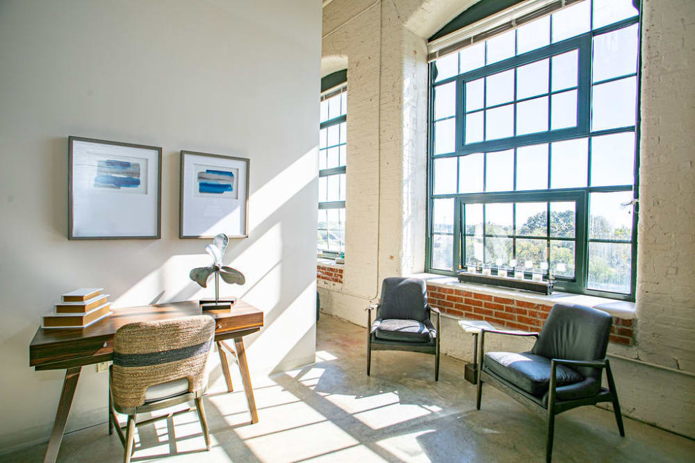 Stylish living space with large windows at Lofts at Riverwalk in Columbus, Georgia