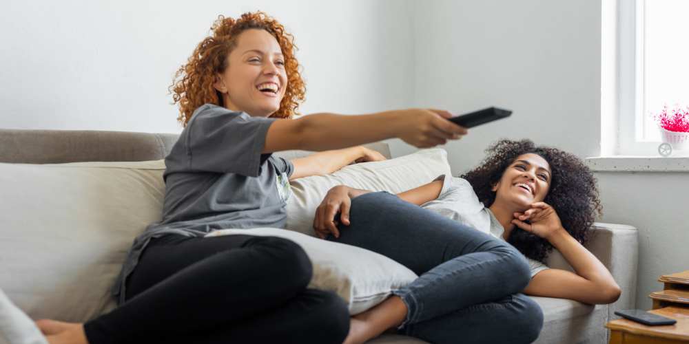 Happy residents in living room at The Bayou District in Gulfport, Mississippi