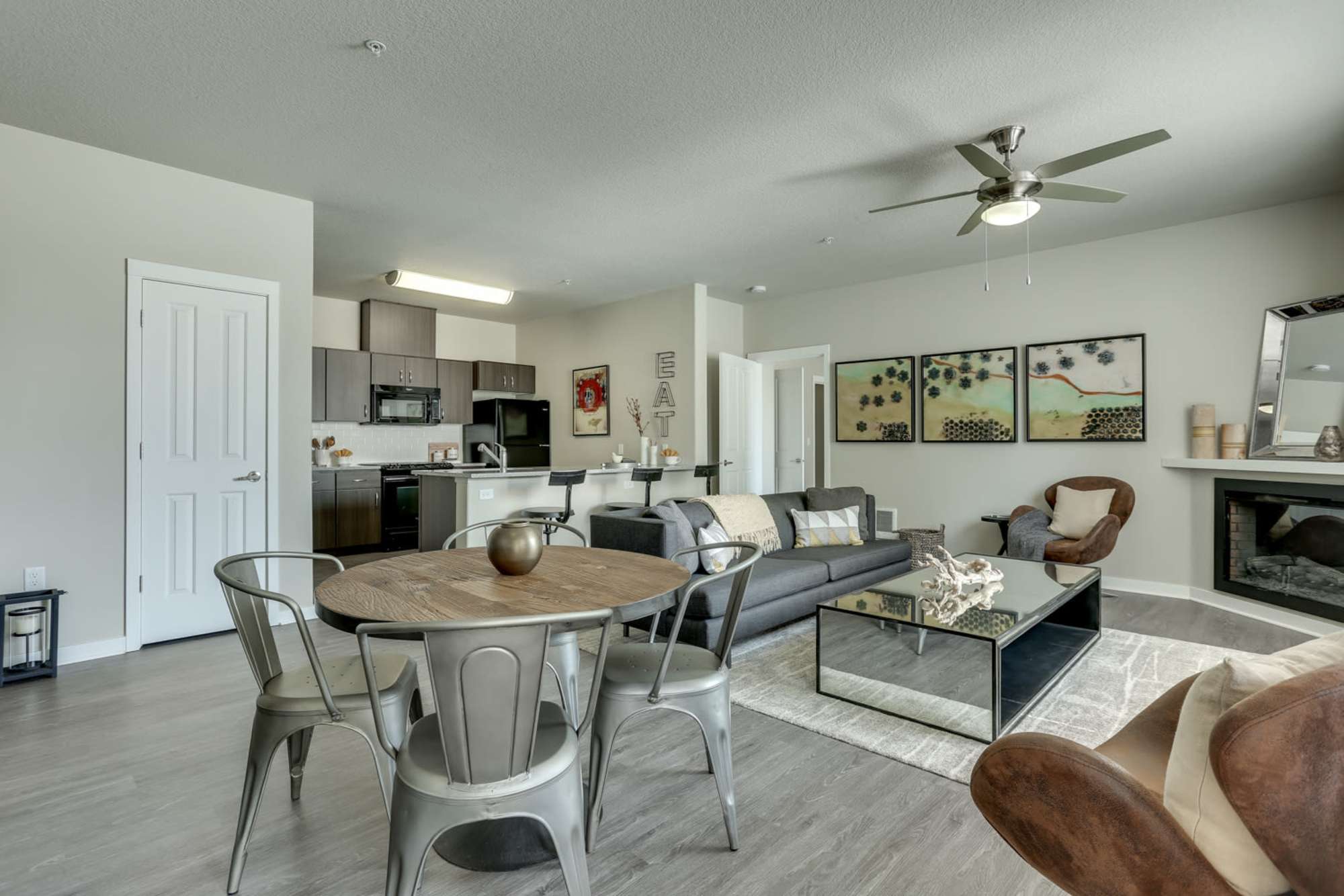 Spacious living room and kitchen with hardwood flooring in a home at Terrene at the Grove in Wilsonville, Oregon