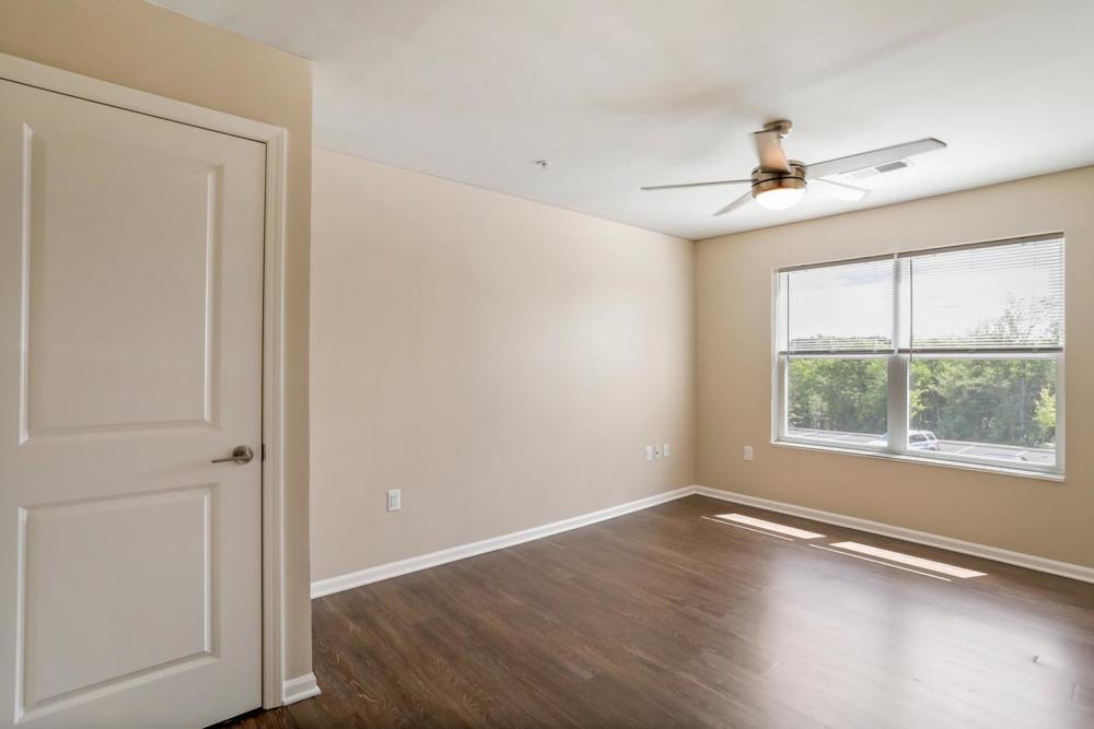 Bedroom with a large window and ceiling fan at Allegany Junction in Cumberland, Maryland