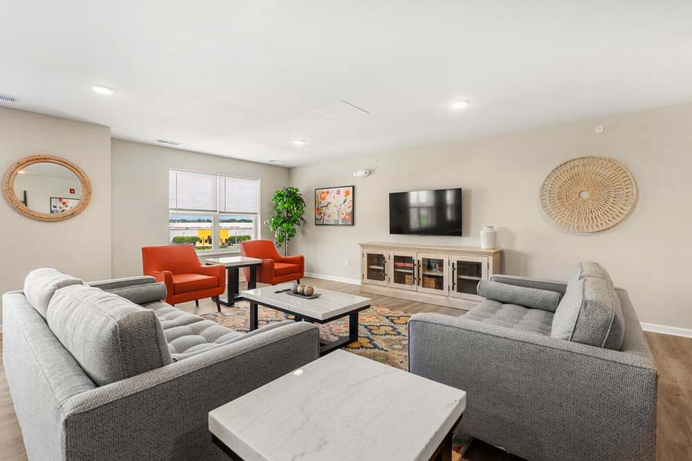 Community room with lounge area at Deville Manor in Oswego, Illinois