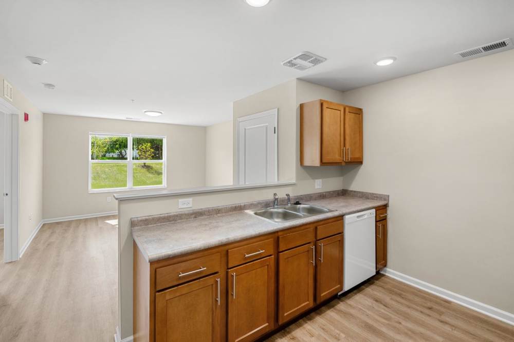 Open kitchen with granite countertops at Deville Manor in Oswego, Illinois