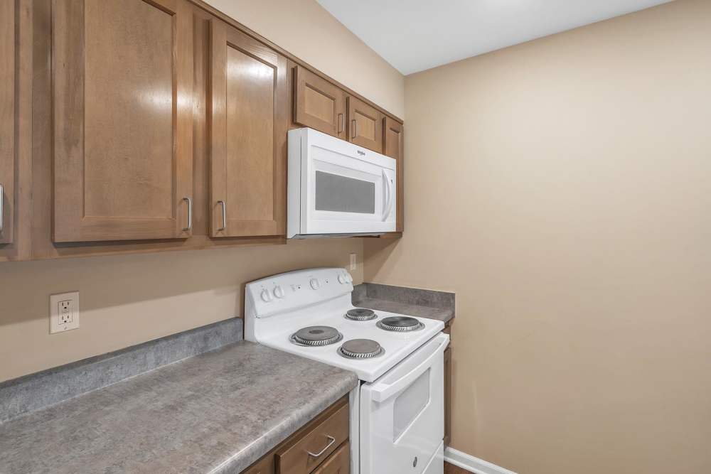 Kitchen with wood cabinetry at The Hamilton in Pontiac. MI