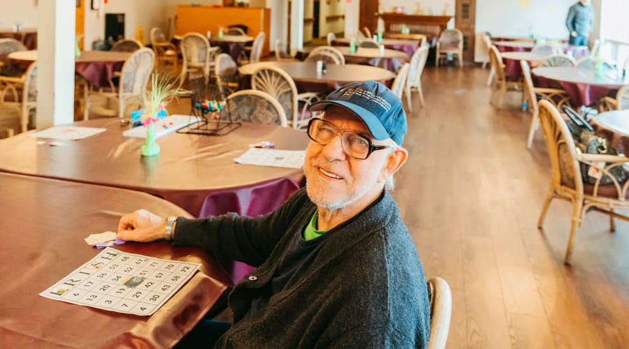 Memory care resident playing bingo at 6th Ave Senior Living in Tacoma, Washington