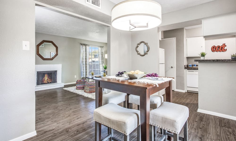 Dining room with living room in back at Estancia Estates in Dallas, Texas