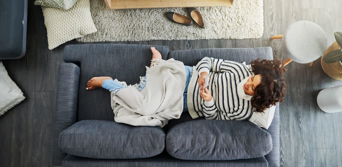 A resident relaxes on her sofa at Arbor Grove, Stafford, Virginia