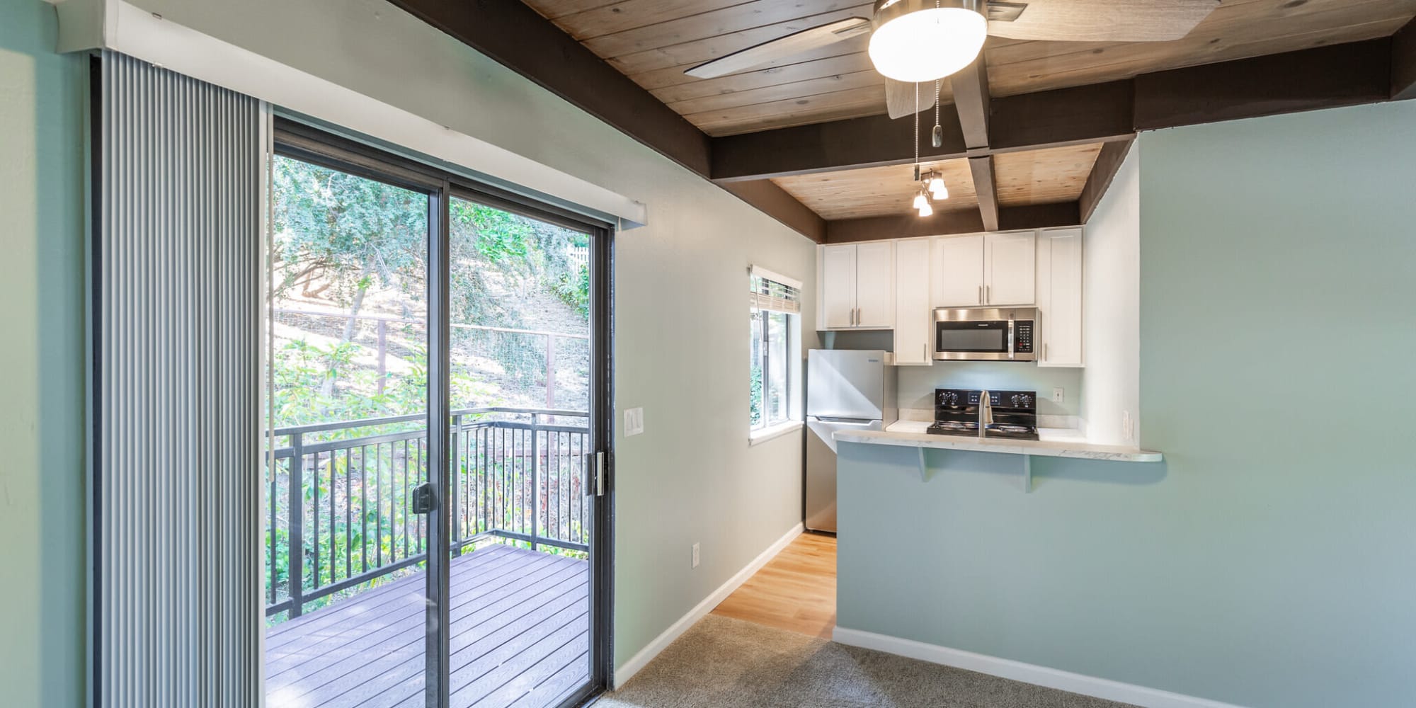 Kitchen with slider door to patio and ceiling fan at  South Knoll in Mill Valley, California