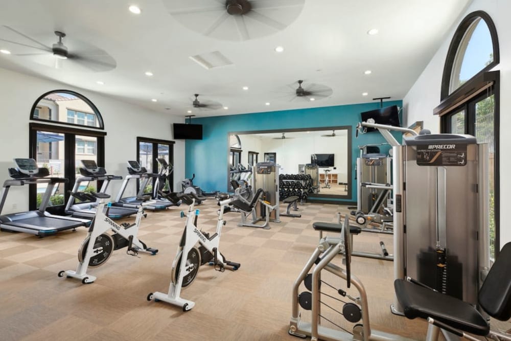 Big workout room full of modern equipment at The Trails at Canyon Crest apartment homes in Riverside, California