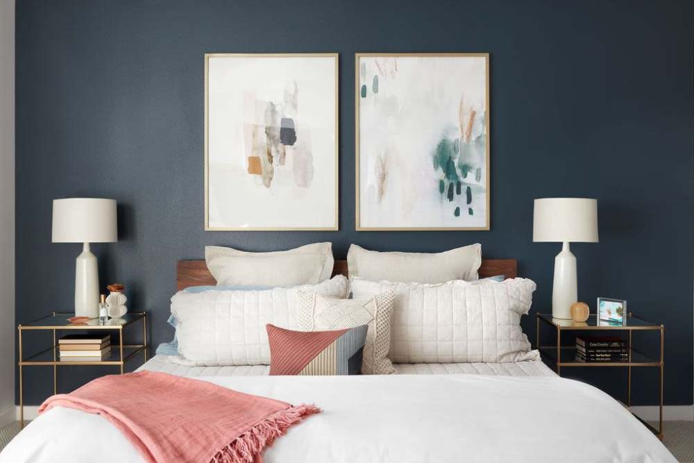 Spacious bedroom with wall paintings and lamps at Ardan in Dallas, Texas 