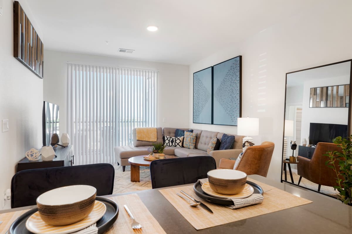 Living room with wood-style flooring at Enova in Commerce City, Colorado