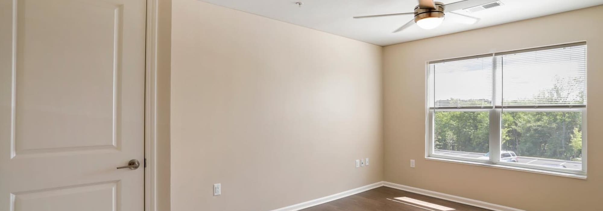 Bedroom with a large window and ceiling fan at Allegany Junction in Cumberland, Maryland