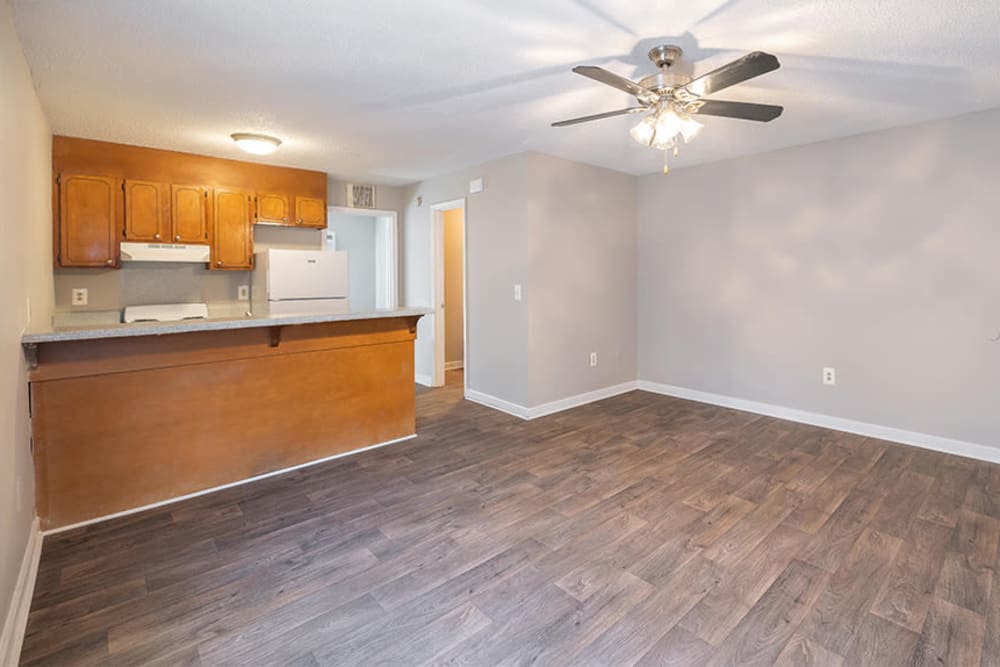 Living room and kitchen with vinyl plank flooring at Wexford Apartment Homes in Charlotte, North Carolina