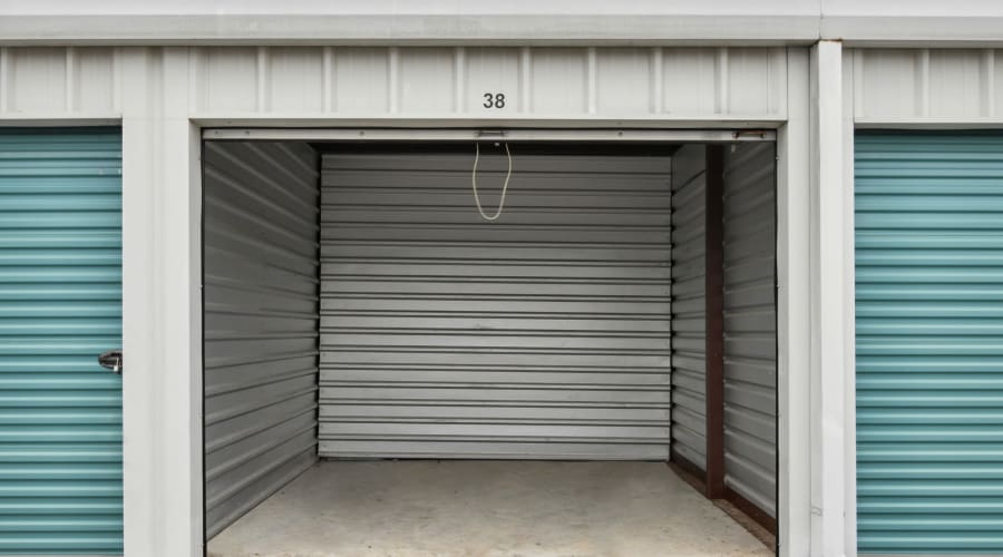 A family carrying storage boxes into their new home near KO Storage in D'Iberville, Mississippi