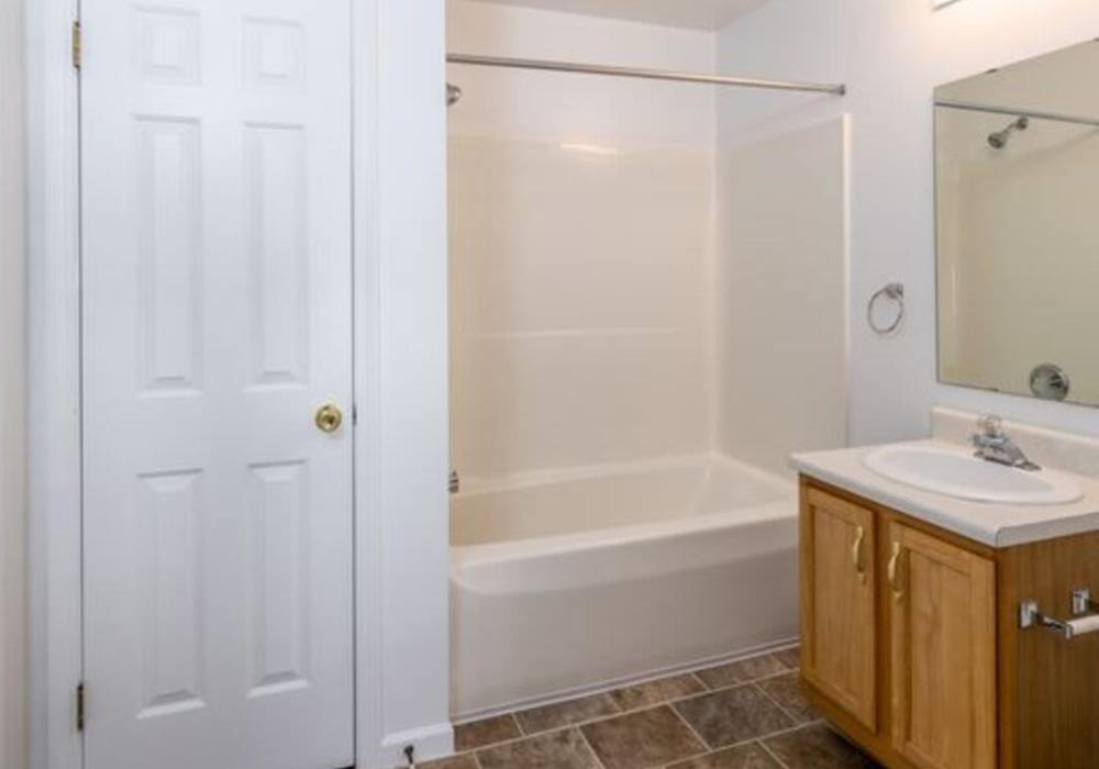 Bathroom with bathtub at Heritage Park Apartments & Townhomes in Webster, New York