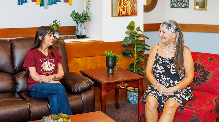 Three generations of a family posing for a photo at Peoples Senior Living in Tacoma, Washington