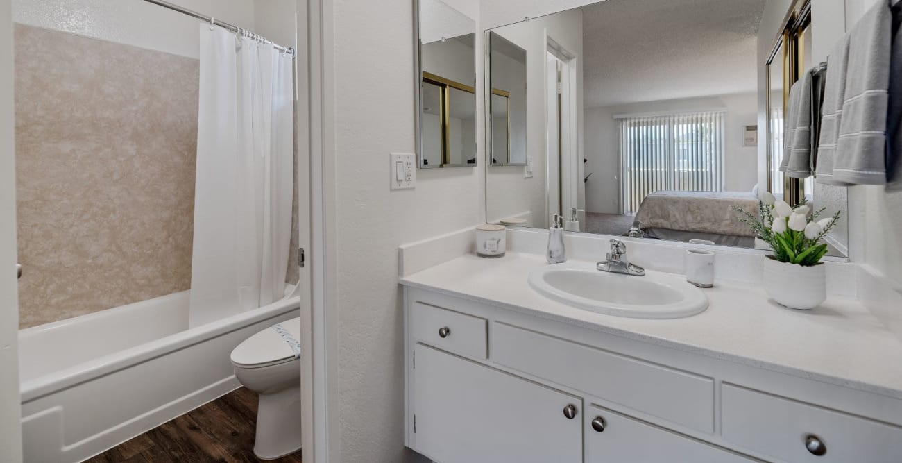 Bathroom with a large vanity, a wall to wall mirror, and a bathtub at Vista Pointe II in Studio City, California