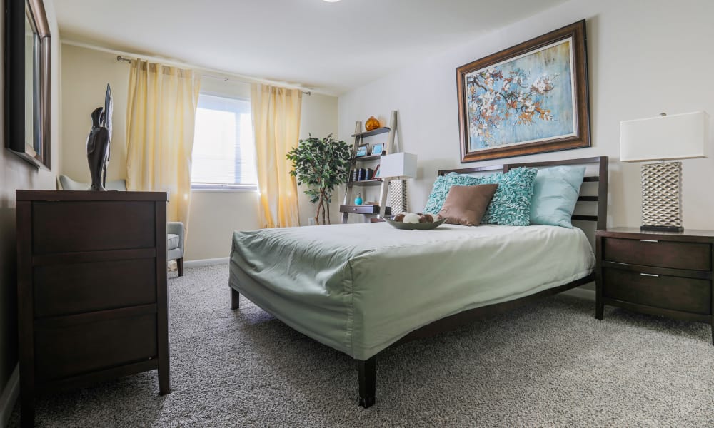 Master bedroom with room for a desk and a large bed at Regency Pointe in Forestville, Maryland
